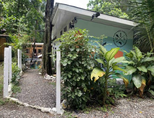 Private bathroom surrounded by tropical plants at Waverii, offering a peaceful retreat in a natural garden environment. Perfect for relaxing stays in a serene location.