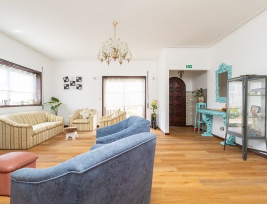 Bright and inviting living room at Women Surf Camp Portugal, featuring comfortable sofas, natural light, and stylish decor, perfect for relaxing after surfing sessions.