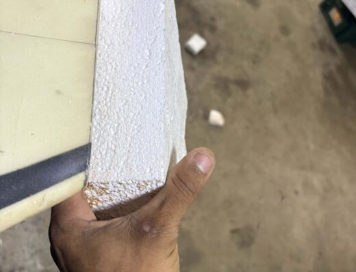 Ding repair process showing a person holding a piece of foam and a surfboard in Pavones, Costa Rica. Expert ding repair services by Waverii to restore surfboards efficiently.