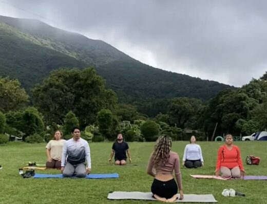 Yoga in nature with mountain views during a group outdoor session.