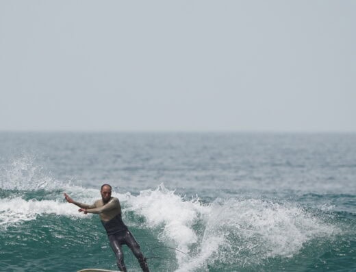 A surfer riding a wave, embodying tranquility and connection with nature.