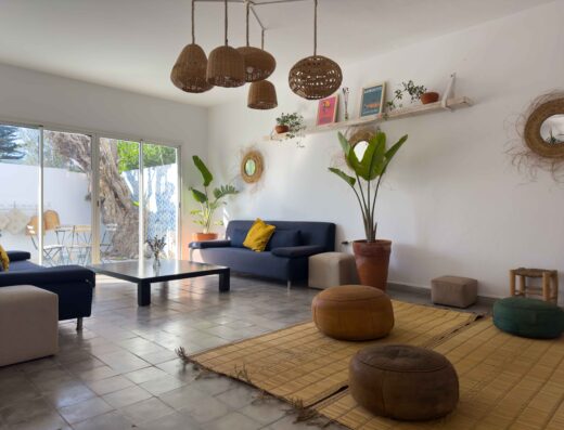 Bright and inviting living space with modern decor, large windows, and natural light, perfect for relaxing after surfing at La Crique Surf House.