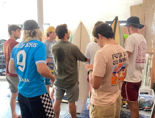 People gathered at Surfshop Padang preparing surfboards for the upcoming surf season. The workshop features surfboard shaping, repair, and customization, attracting surfing enthusiasts and local surfe.
