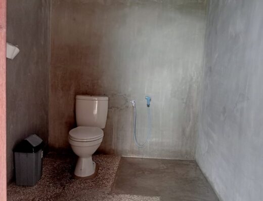 Basic outdoor toilet at Waverii Surf Homestay in Katiet, ideal for surfers and travelers seeking authentic accommodations near surf spots.