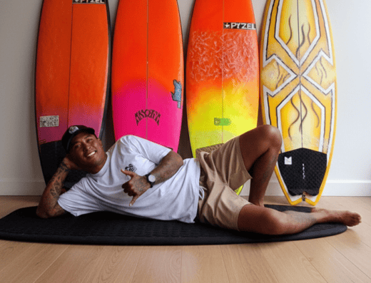 Indoor surfboard display with four colorful boards at Bali surf lessons studio, showcasing equipment for surfing lessons in Bali.