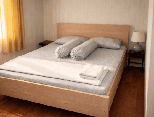 Cozy bedroom at Fideluna Beach Bungalow, perfect for relaxing after a day of surfing at Fideluna Beach. Comfortable bed with soft linens, ideal for a peaceful stay in a tropical setting.